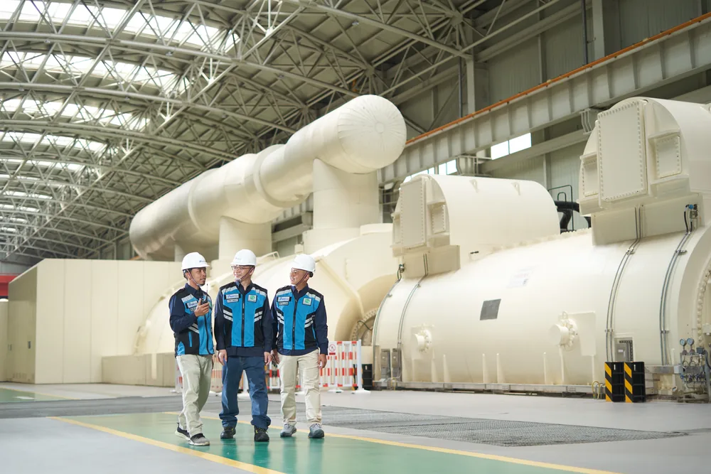 Engineers inspecting the turbine generator hall